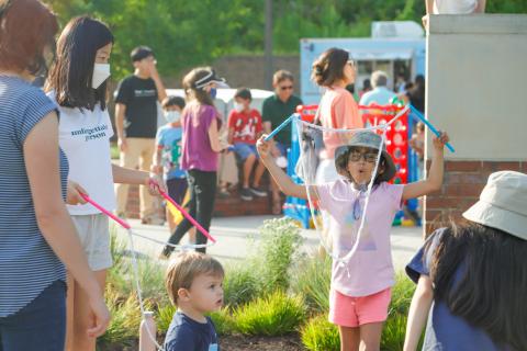 A child blows a bubble during a Family Fun Friday event